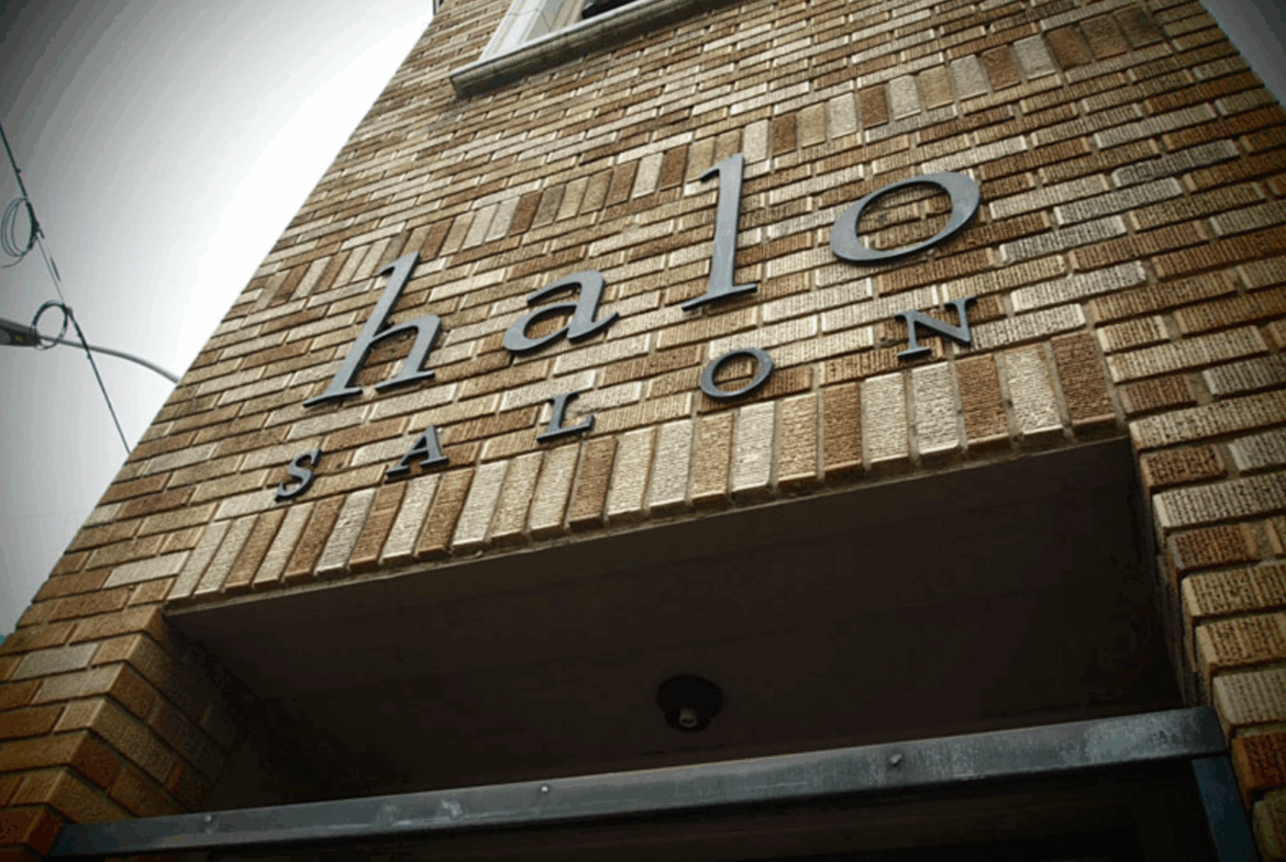 Exterior shot of a brick building with "Salon" sign, showcasing salon business location.
