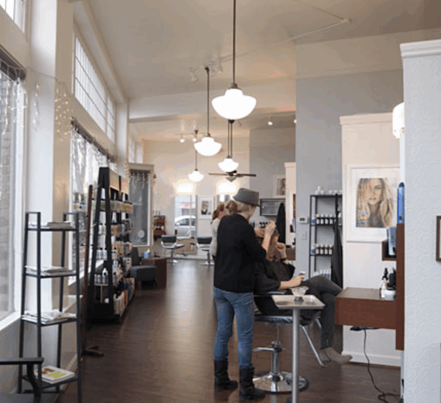 Bright salon with modern styling stations and natural lighting.