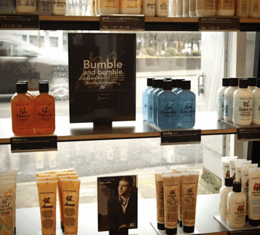 High-quality hair treatment bottles arranged on shelves in a salon setting.