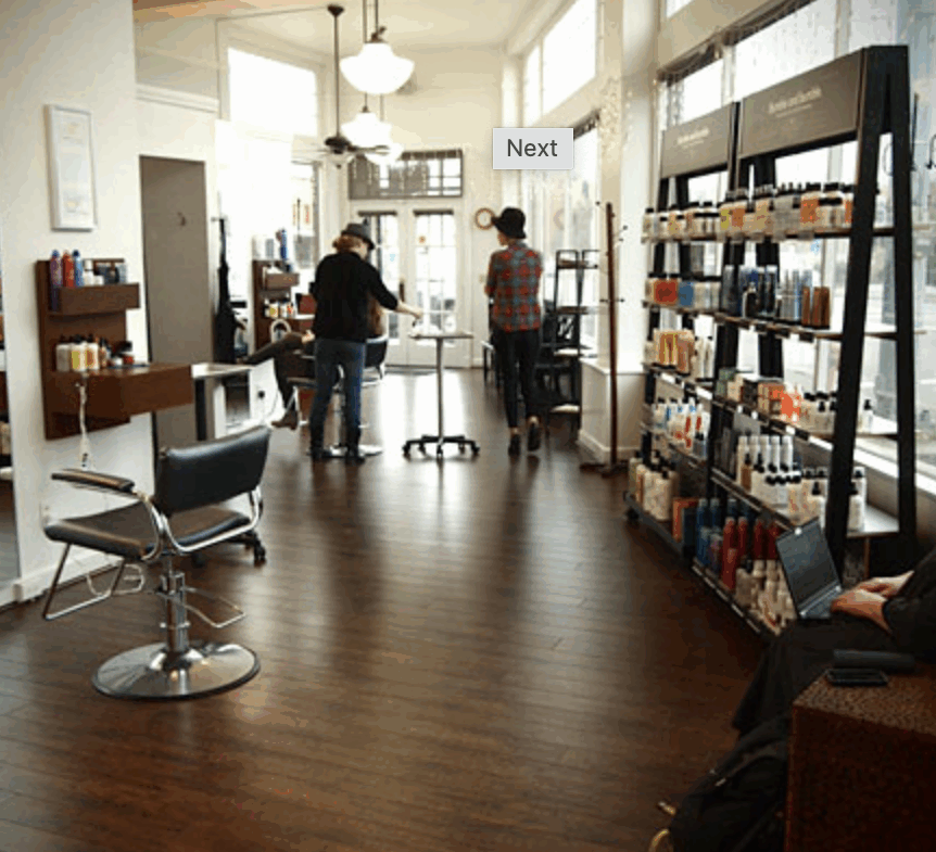 Bright salon with hair and beauty products, styling chairs, and customer seating area.