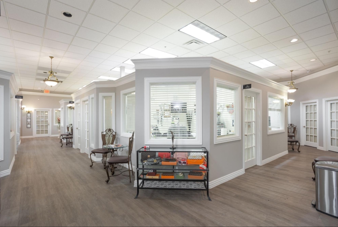 Spacious salon with classic chairs, large windows, and stylish decor for rent or leasing.