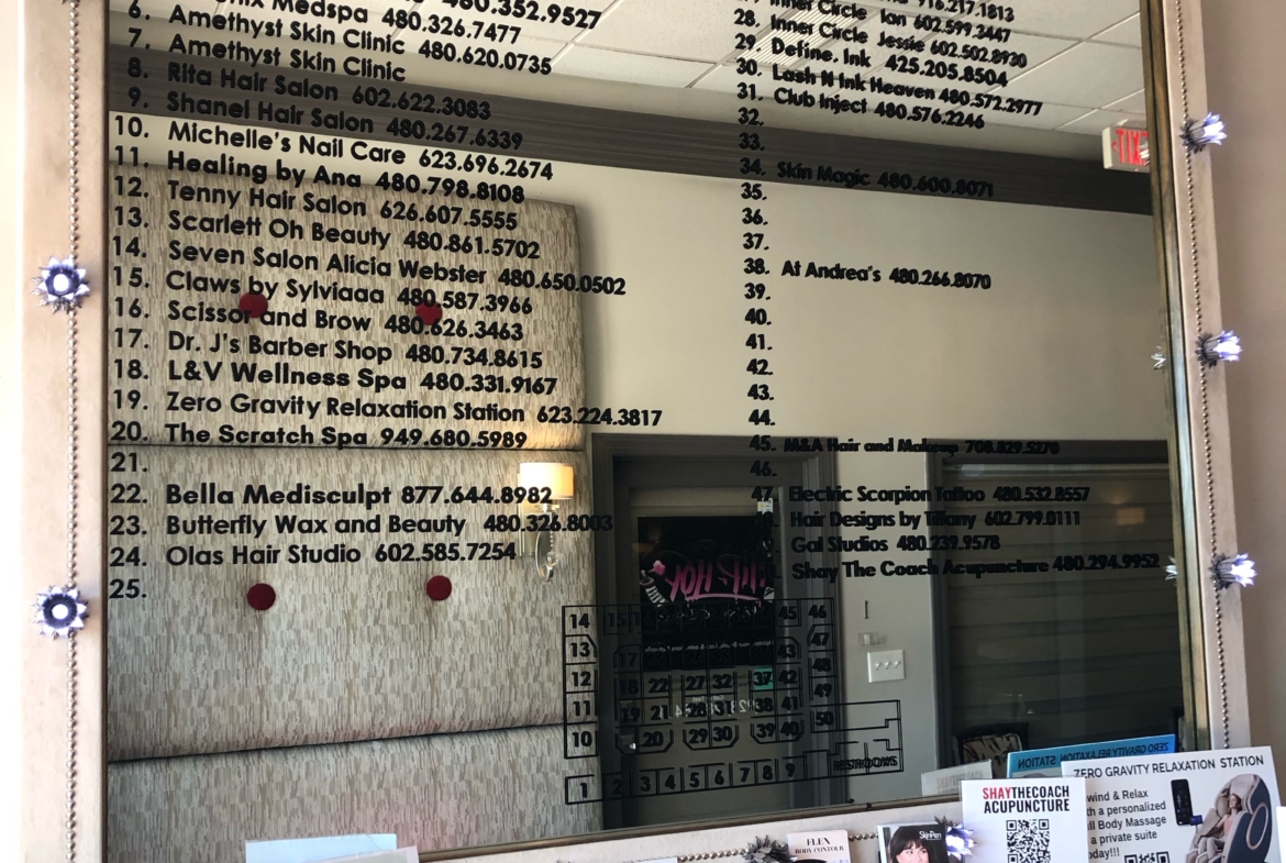 Elegant salon directory display with business names, phone numbers, and promotional cards at Salon Renter.