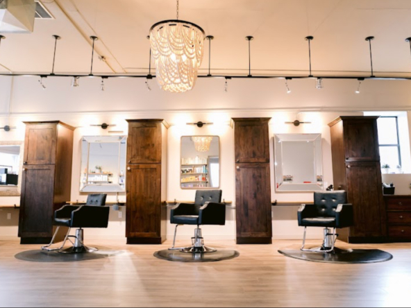 Modern salon with stylish chairs, mirrors, and organized workspace for hair and beauty services.