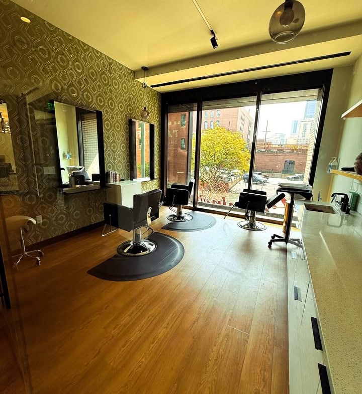 Modern salon interior with styling chairs and large windows for rent | Salon Renter.