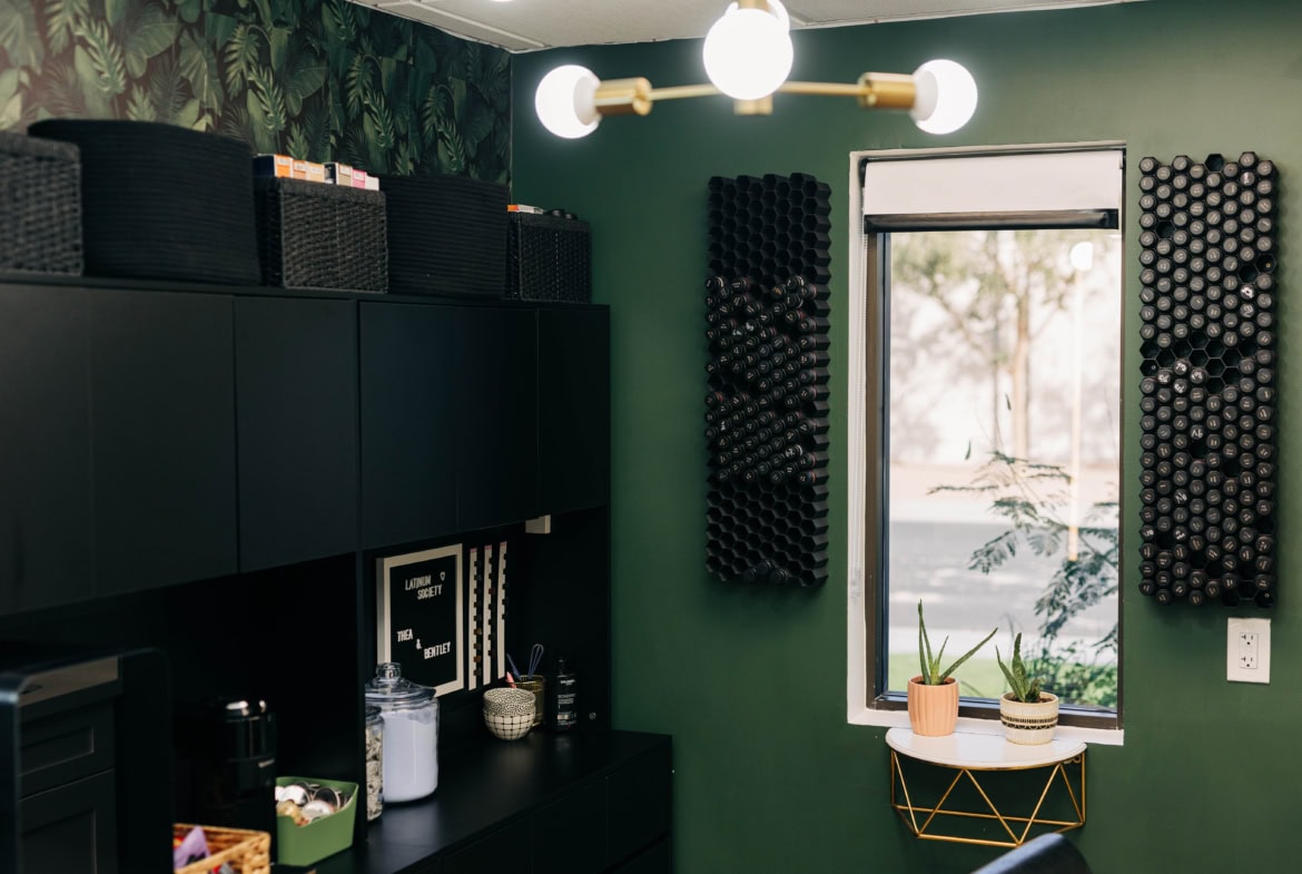 1. Modern salon with organized hair product storage and stylish lighting.