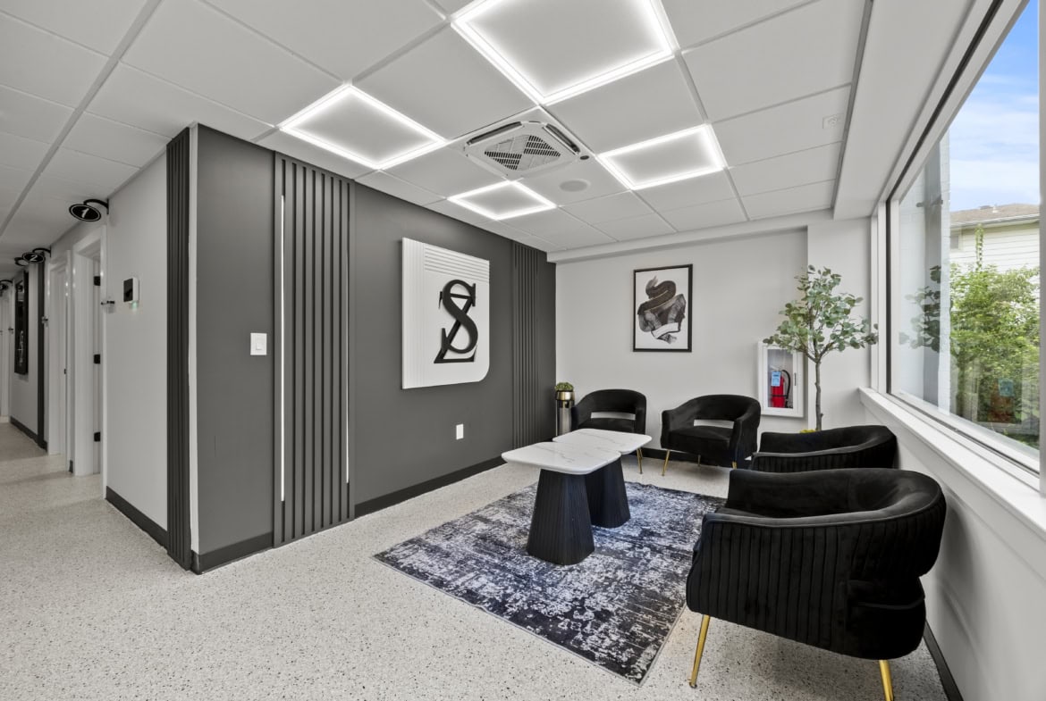 Modern salon reception area with stylish seating and branding, ideal for salon rental spaces.