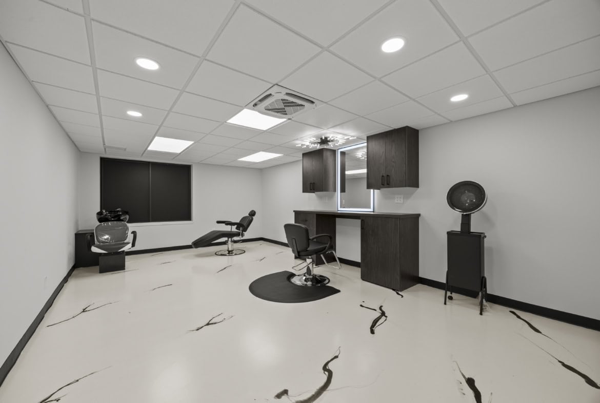 Modern salon studio with styling chairs and hair washing stations, ideal for rent or lease.