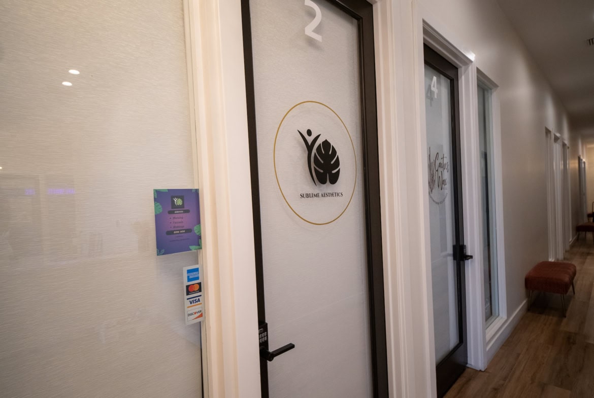 Modern salon suite doors with branding and sleek design for rental spaces.