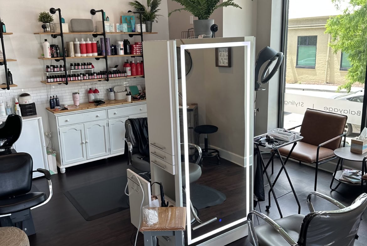 Stylish salon in a bright, welcoming space with hairdressing stations and decor.