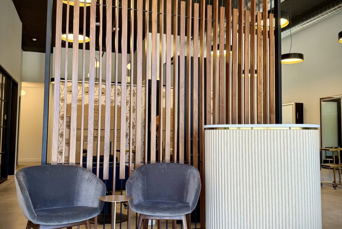 Modern salon reception area with stylish chairs and contemporary decor.