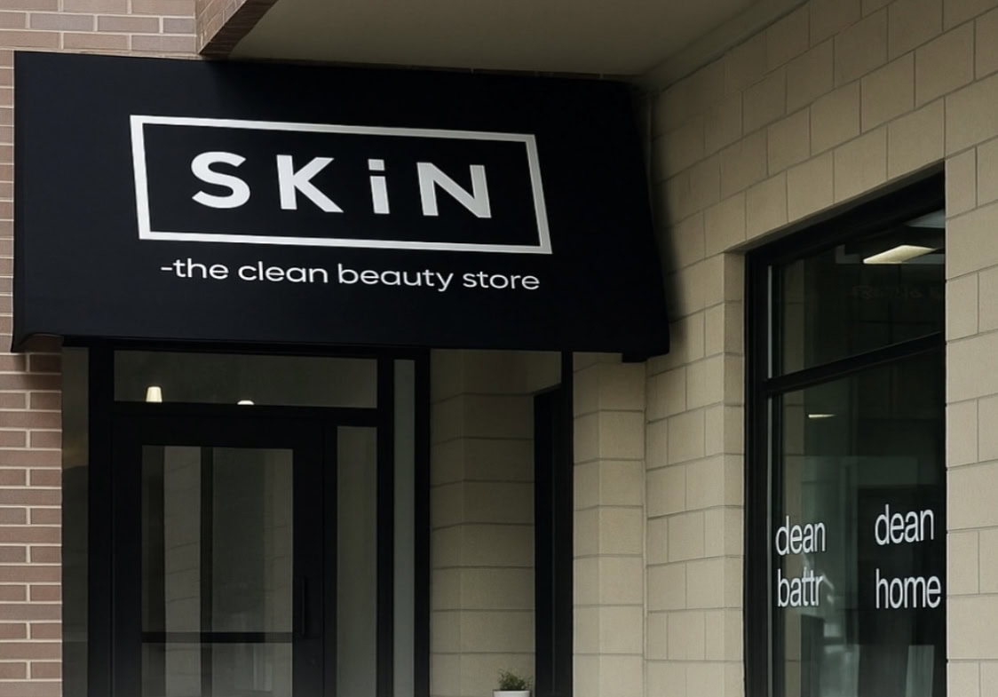 Modern beauty store storefront with sleek black signage and minimalist design.