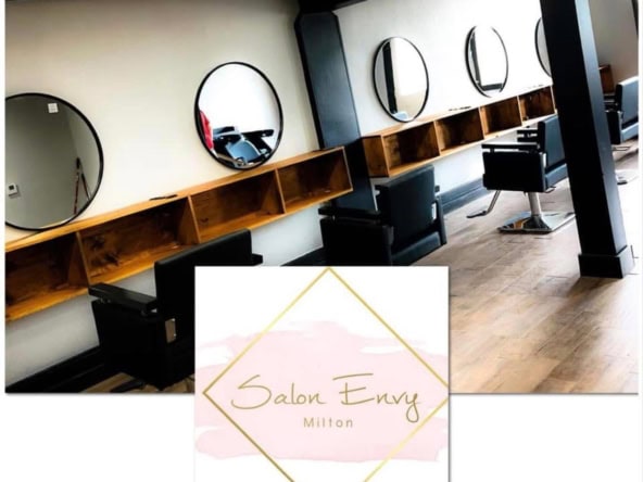 Stylish salon chairs with mirrors in modern salon rental space, showcasing professional hair station setup.