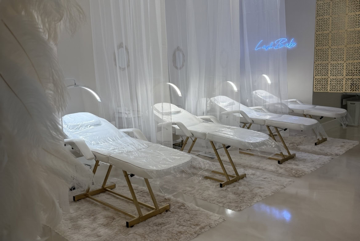Stylish beauty salon treatment beds with modern lighting and luxurious decor for relaxing client experiences.