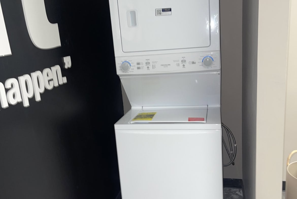 Stackable washer and dryer appliance in a salon setting.