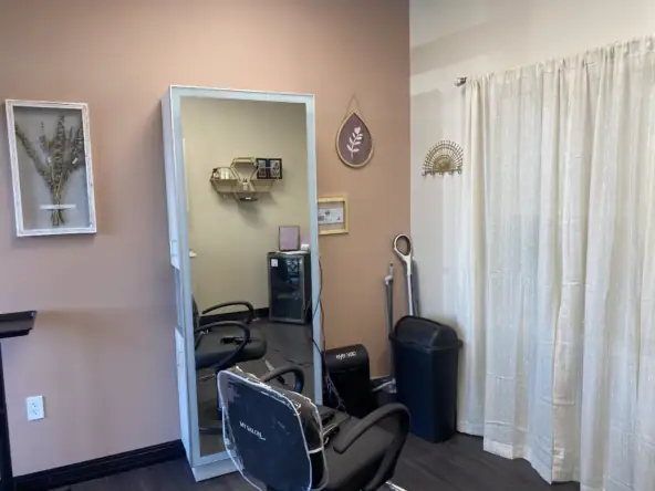 Bright salon station with mirror, chairs, and decor, perfect for salon renters and stylists.