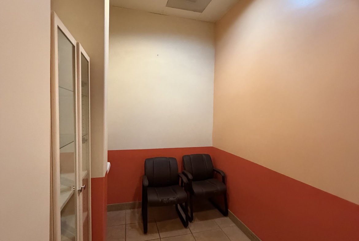 Comfortable salon waiting room with chairs and calming decor.
