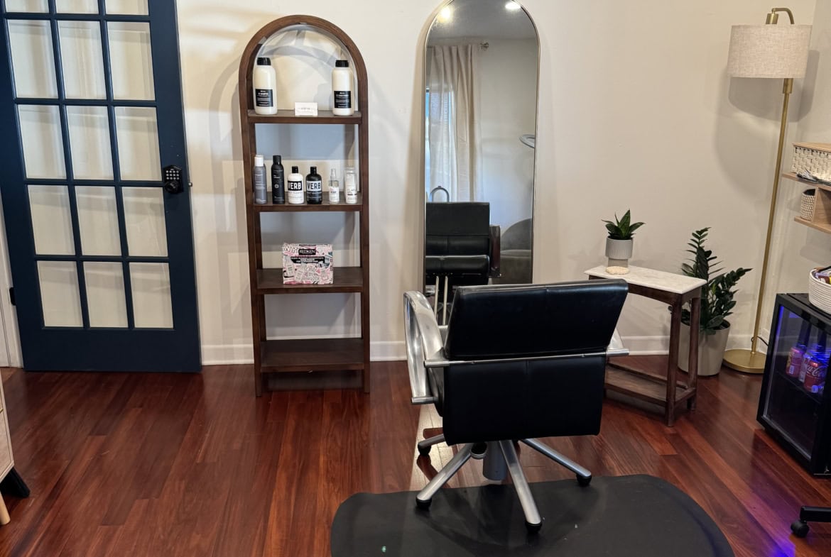 Clean salon styling station with mirror and products, perfect for hair and beauty professionals.