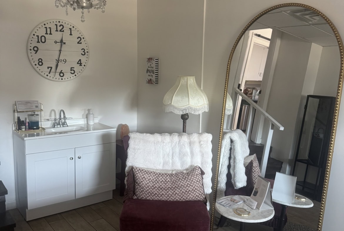 Elegant salon break room with vintage decor, mirror, and cozy seating, ideal for salon professionals.