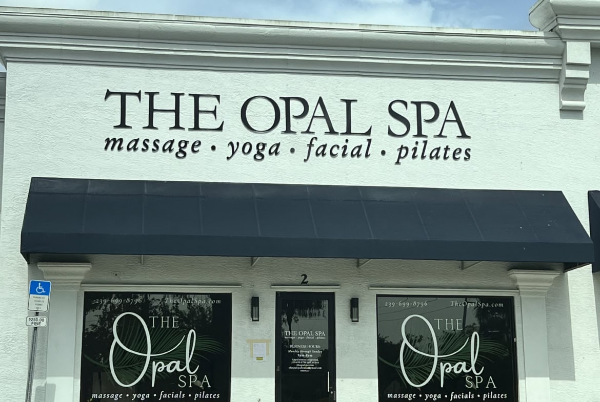 Elegant spa storefront with massage, yoga, facial, and Pilates services at The Opal Spa.