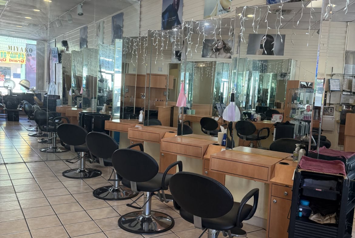 Stylish salon workstations with mirrors, chairs, and professional hairdressing equipment.