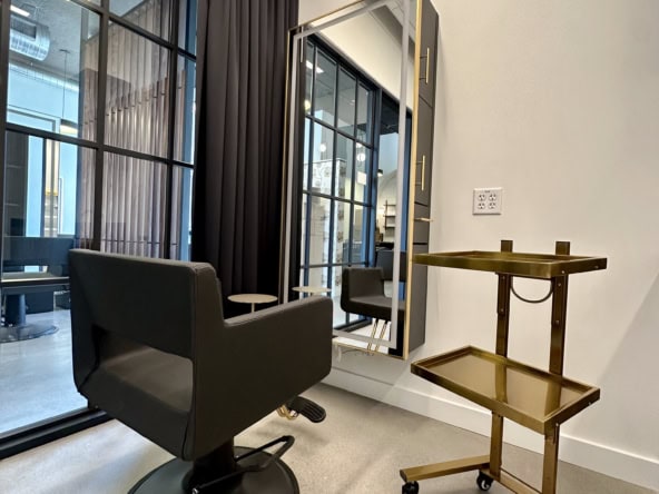 Modern salon styling station with chair and mirror, ideal for salon rental and hair styling services.