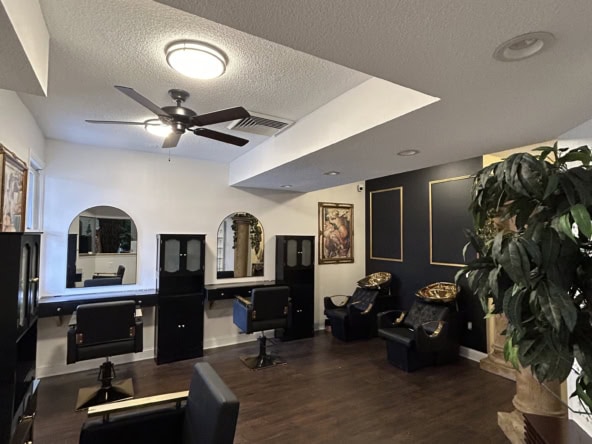 Stylish salon interior featuring modern styling stations, comfortable chairs, and elegant decor.