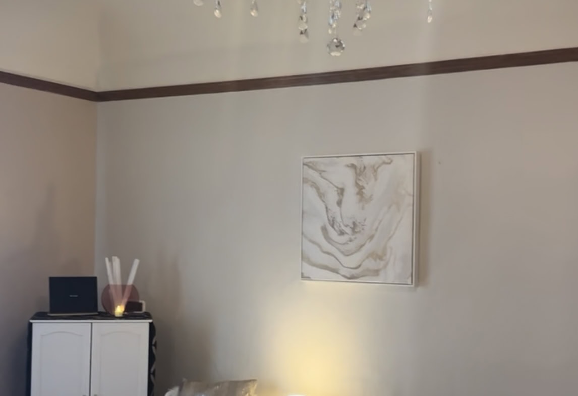 Luxurious chandelier lighting enhances modern salon ambiance.