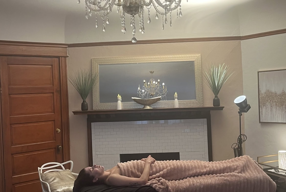 Luxurious chandelier illuminates a serene spa or salon treatment space.