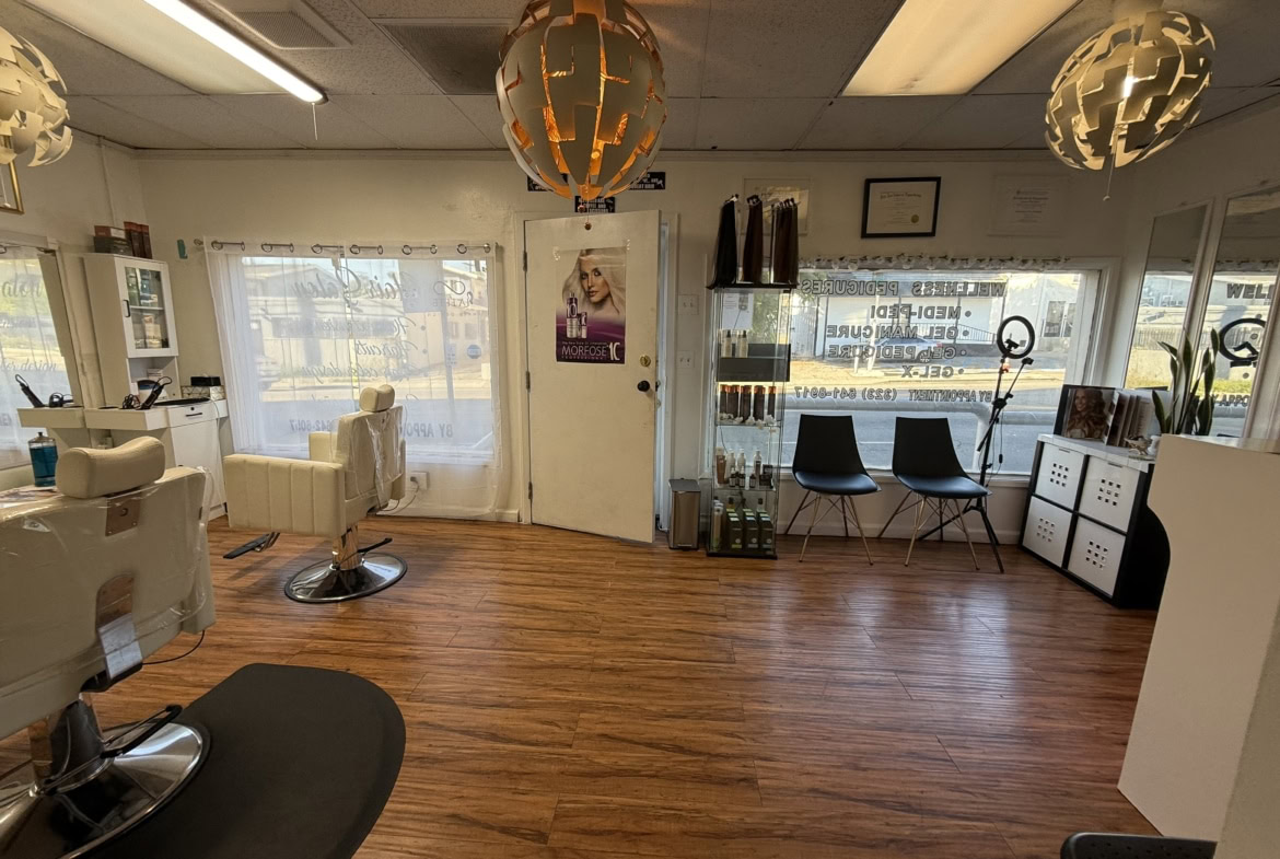 Comfortable salon interior with styling chairs and large windows for rent or lease.