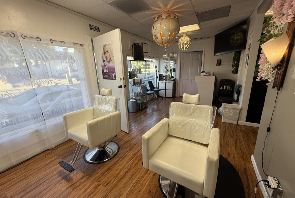 Stylish salon interior with modern chairs and warm lighting, ideal for hair and beauty services.