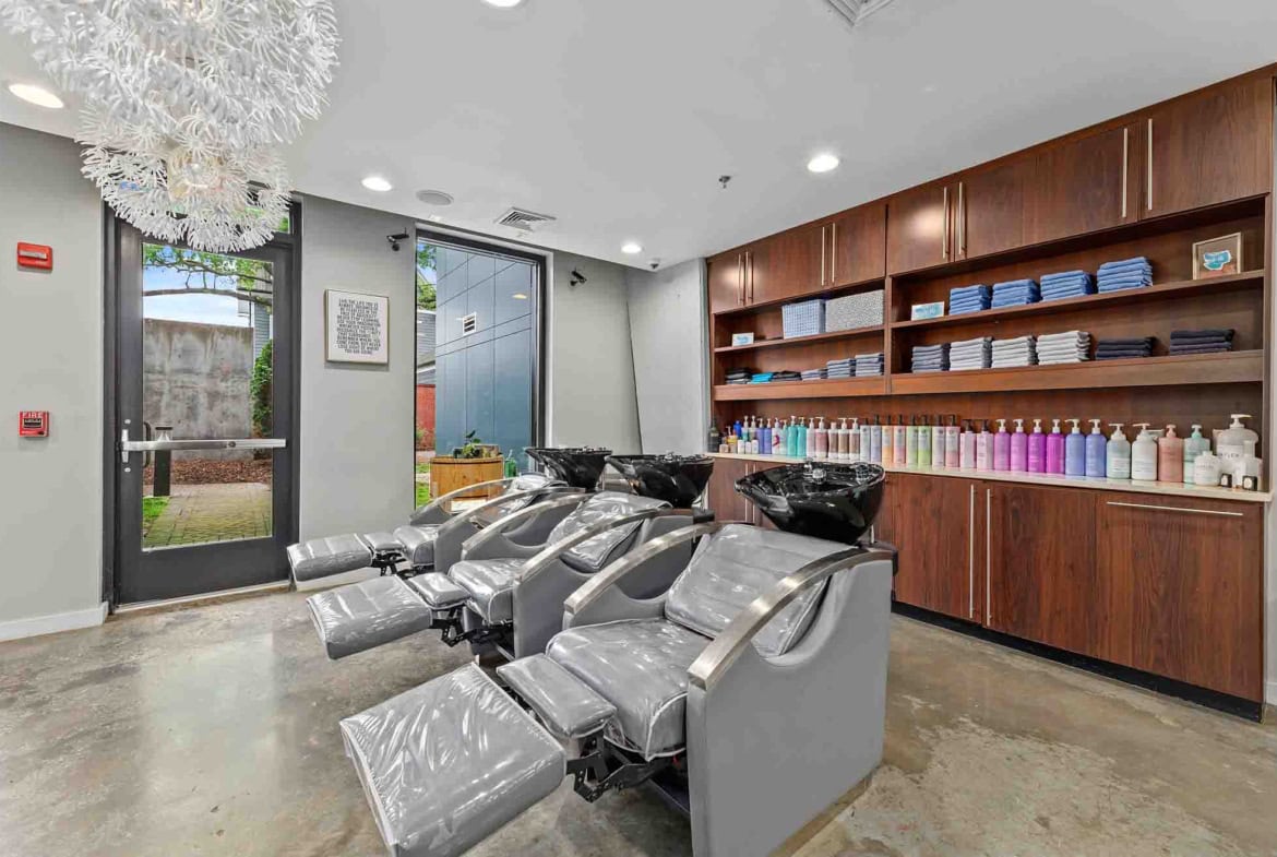 Bright salon interior with styling chairs, hair products, and accessible entrance for clients.