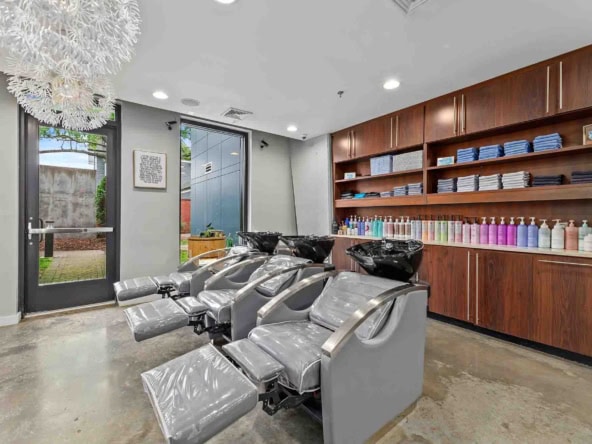 Bright salon interior with styling chairs, hair products, and accessible entrance for clients.