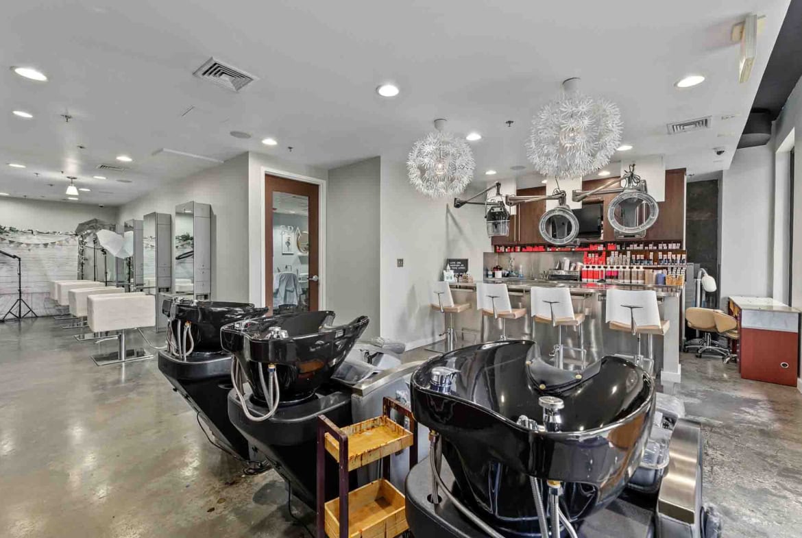 Bright, spacious salon with hair washing stations and styling chairs for rent or lease.