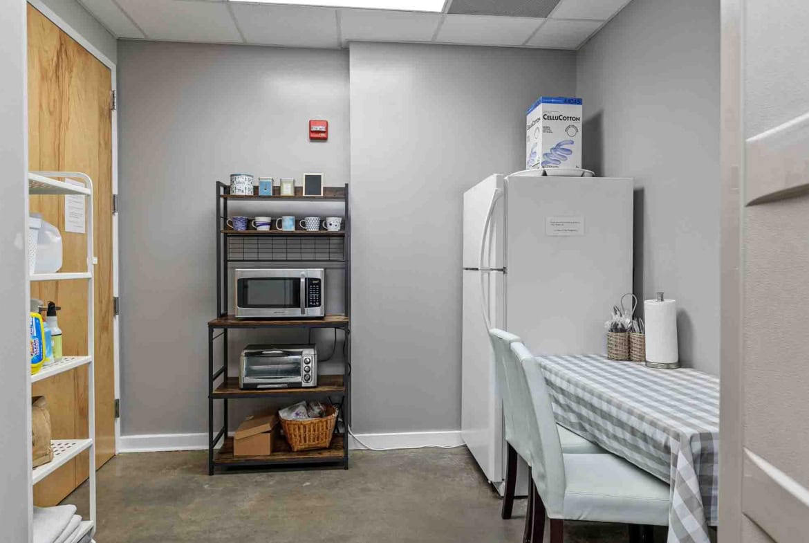 Clean salon with kitchenette, microwave, and coffee station for rent.