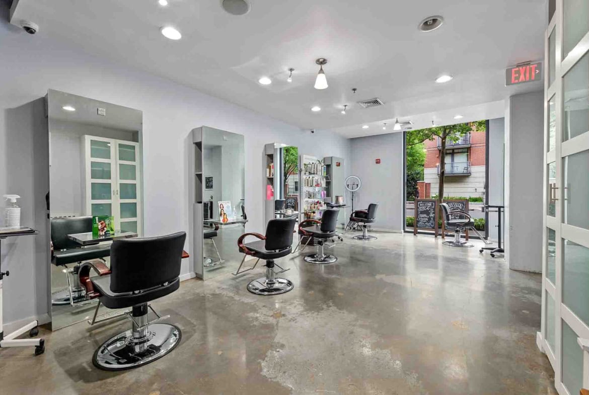 Stylish hair salon interior with chairs, mirrors, and natural light, ideal for hair and beauty professionals.