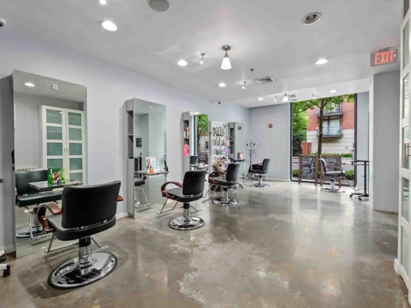 Stylish hair salon interior with chairs, mirrors, and natural light, ideal for hair and beauty professionals.