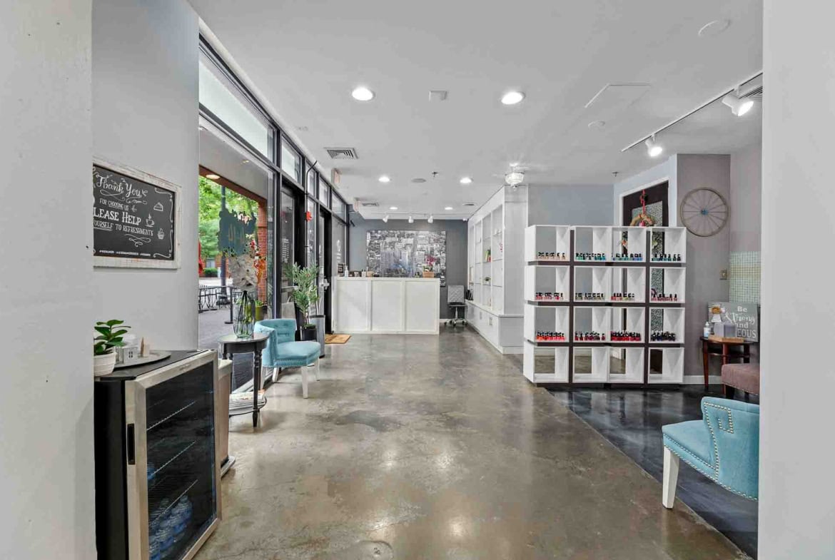 Bright salon reception area with modern decor, seating, and product displays for rent-ready professionals.