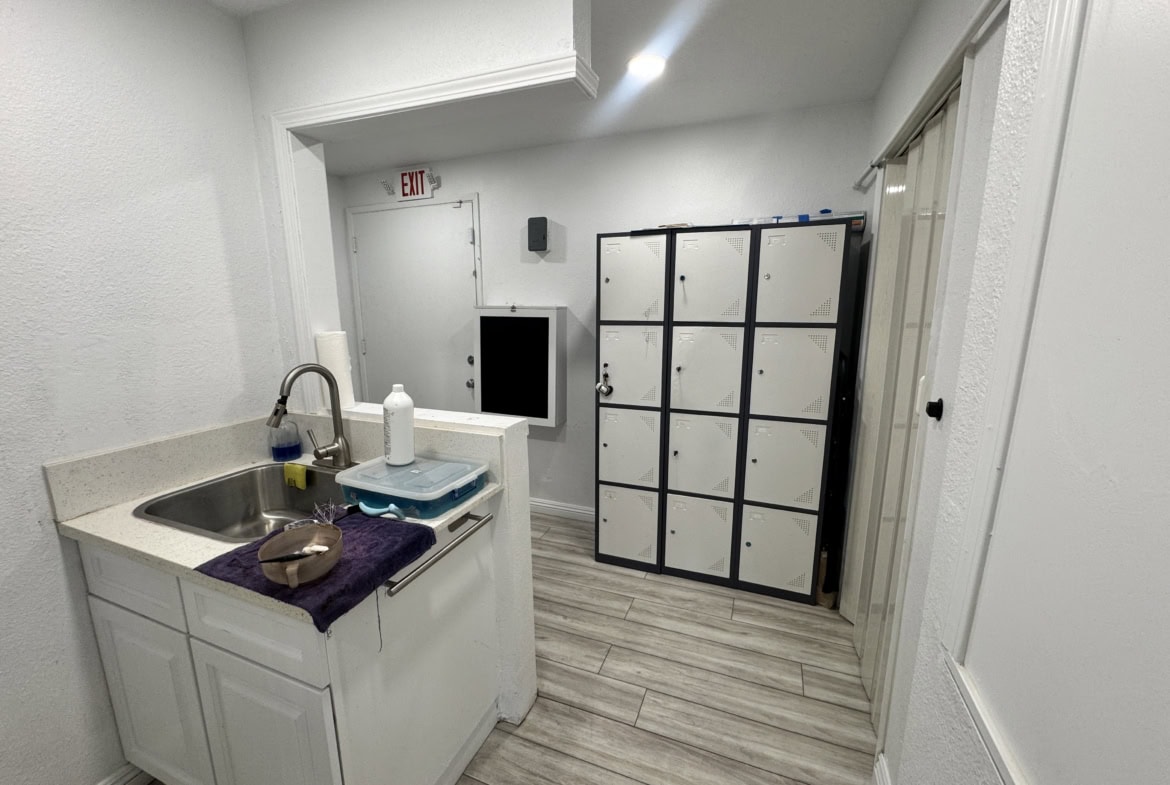 Lockers and utility sink in salon break area, modern and organized for salon professionals.