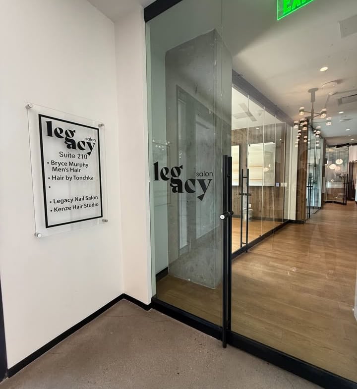 Bright modern salon entrance with glass doors and professional signage for salon rental services.