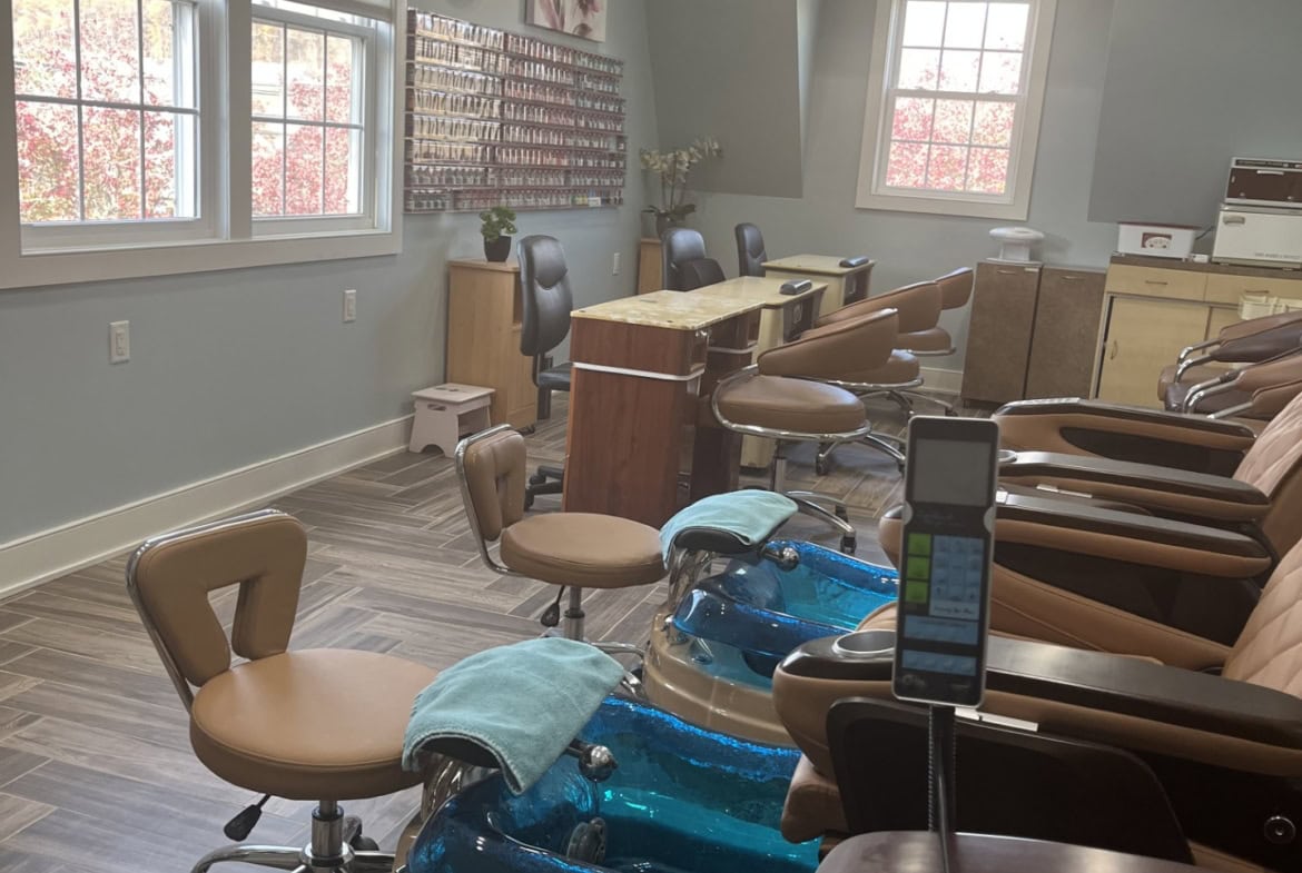 Relaxing salon pedicure chairs with foot baths, comfortable seating, and natural light.