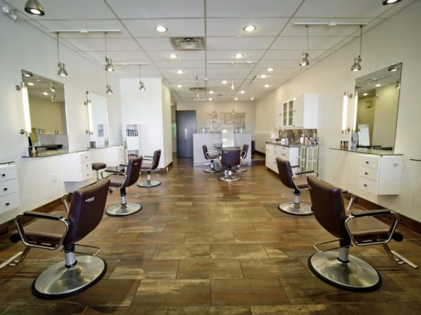 Bright salon with styled chairs and mirrors for hair styling services.