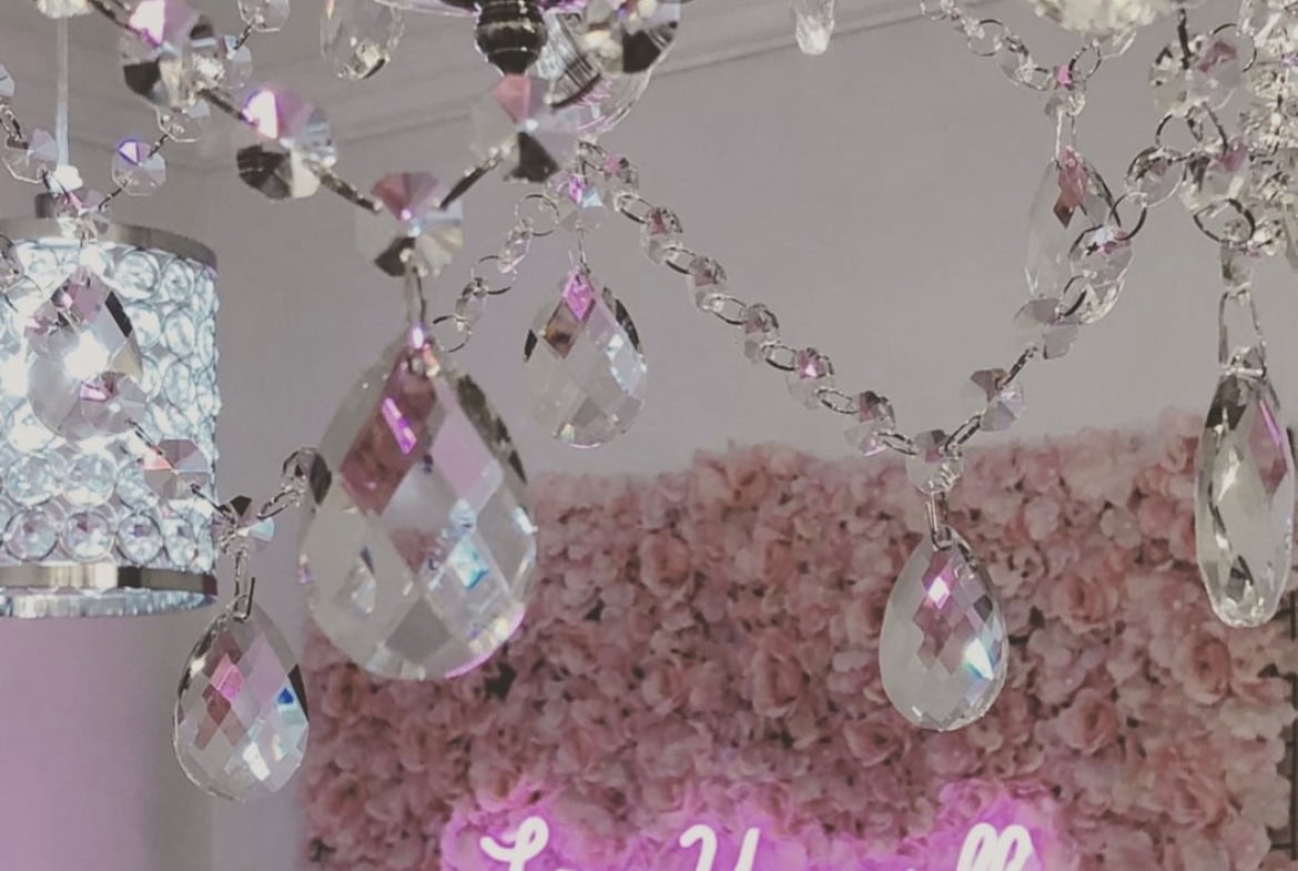 Elegant chandelier with crystal prisms in a chic salon setting showcasing luxury and style.