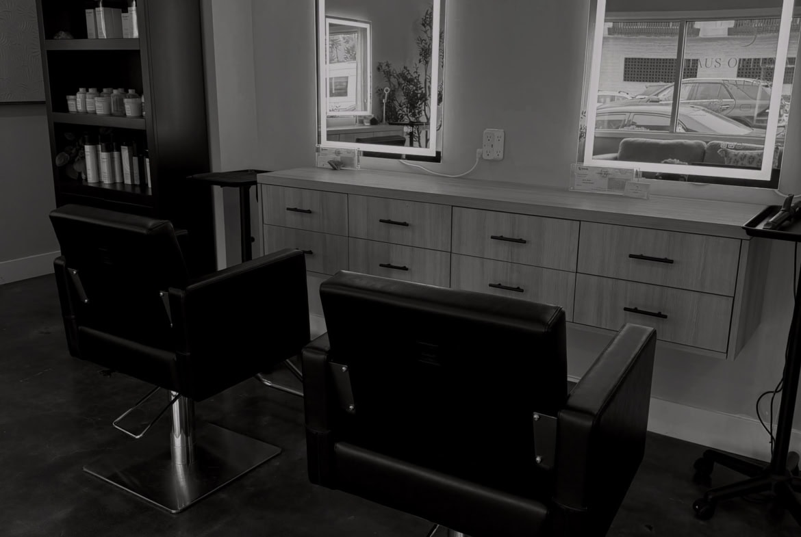 Clean, professional salon interior with styling chairs and mirrors for hair services.