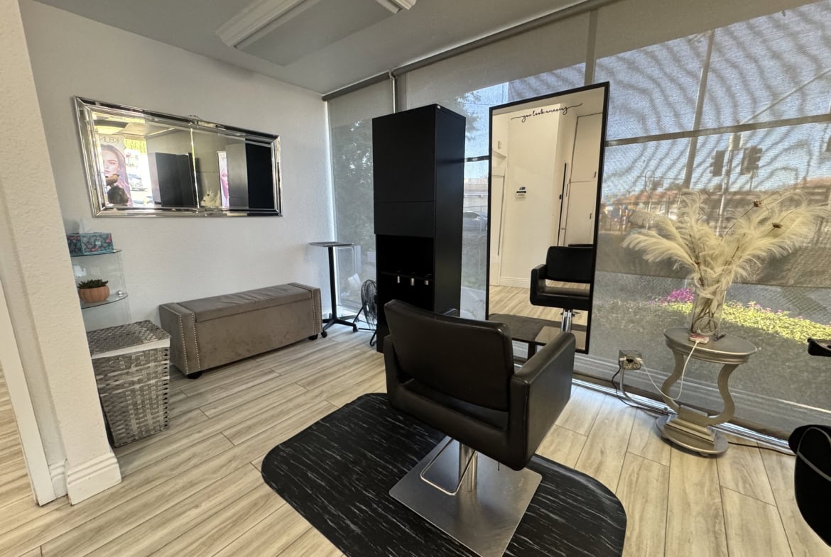 Modern hair salon interior with styling chair, mirror, and decorative elements, perfect for salon renter spaces.