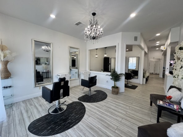 Modern salon interior with styling stations, mirrors, and elegant decor, perfect for beauty and hair services.