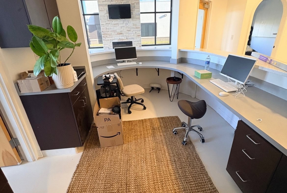 Office space for salon renters with desks, computers, and seating in a bright, modern environment.