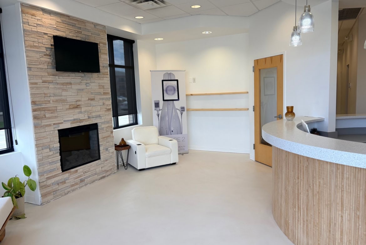 Modern salon reception area with cozy seating and stylish decor.