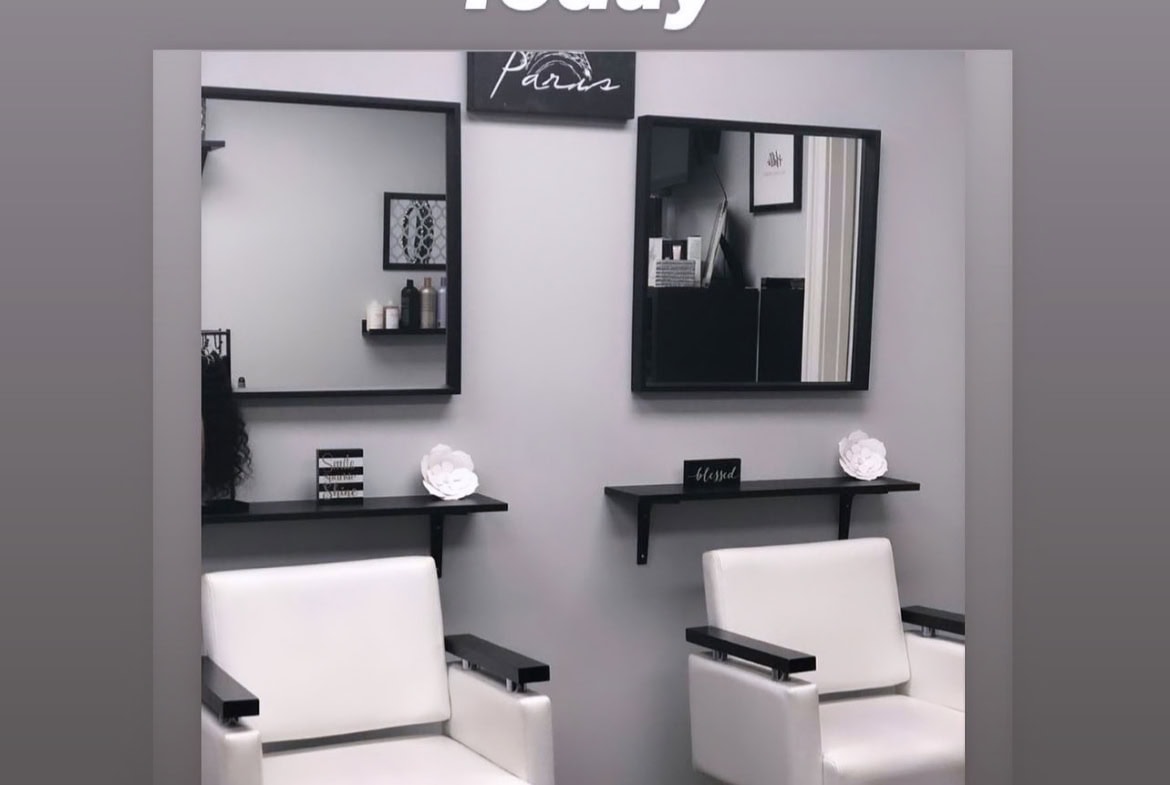 Stylish salon station with mirrors and chairs for hair styling services.