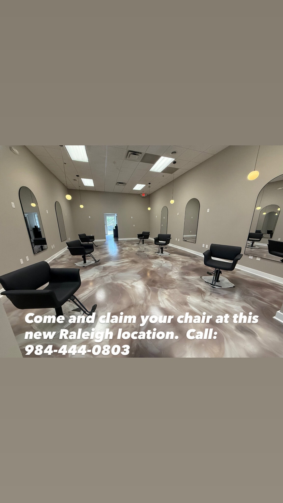 Modern salon with styling chairs and mirrors in Raleigh, NC.