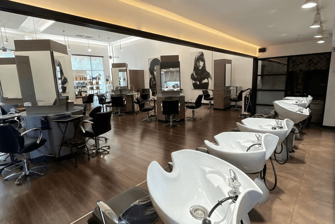 Modern hair salon interior with wash stations, styling chairs, and mirrors for professional hair ser.